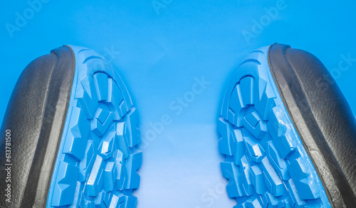A pair of protective work shoes with blue soles for the protection of workers on a blue background photo
