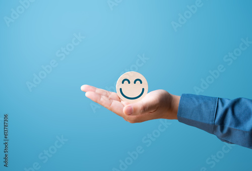 Wooden label with smiley happy and relaxed face. Good score rating, Think positive, Customer feedback review, assessment, satisfaction. World mental health day. Mental state health, Good or calm mood.