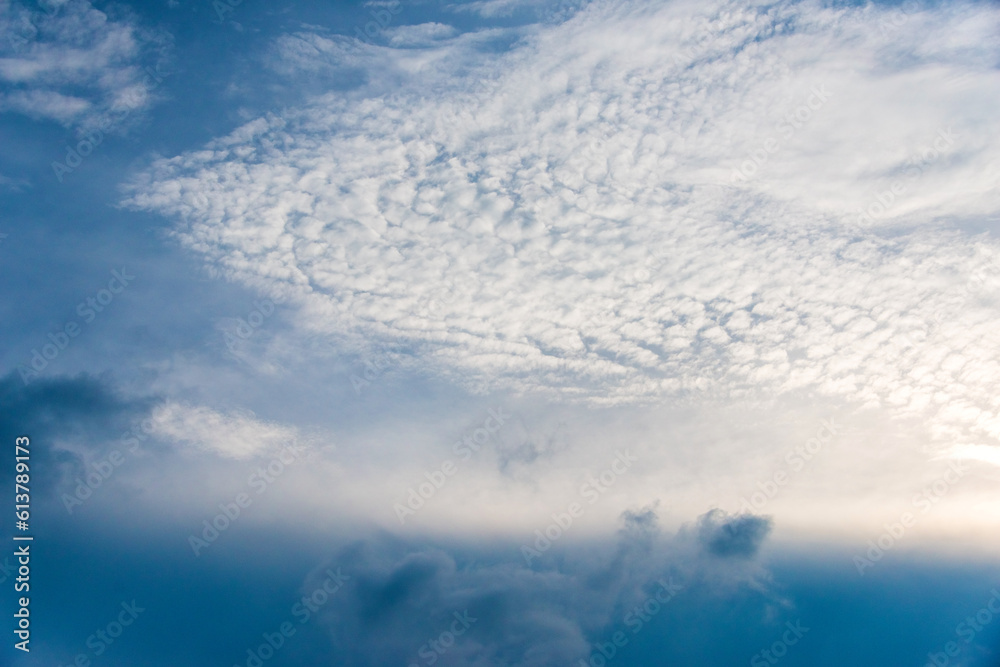 Scattered cloud clusters in a blue sky, blue sky background with white clouds. Scattered cloud clusters in a blue sky, blue sky background with white clouds.