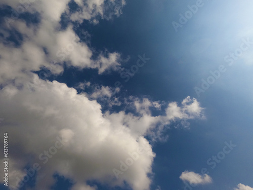 Scattered cloud clusters in a blue sky, blue sky background with white clouds. © shaadjutt36