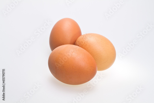 Three Brown Eggs on White Background