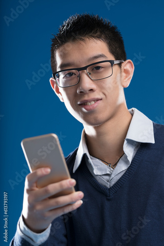 Asian man with smartphone accessing apps, internet, and AI photo