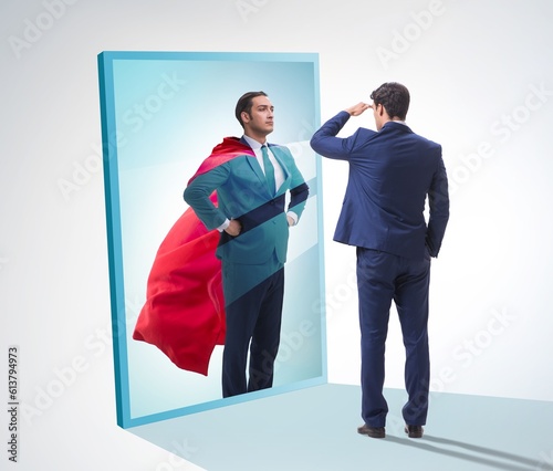 Obraz na plátně Businessman seeing himself in mirror as superhero
