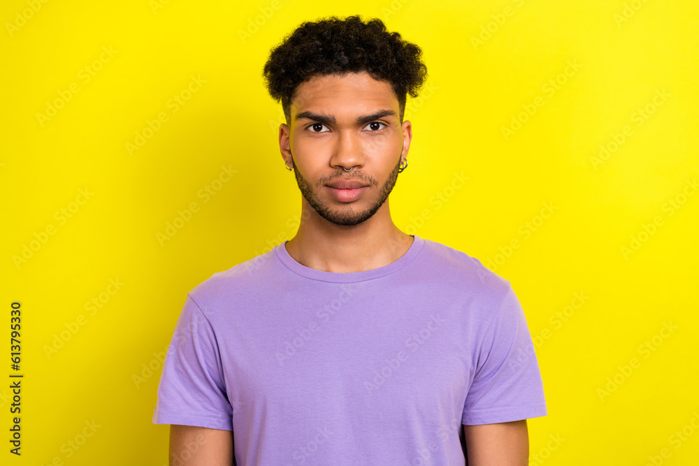 Photo of serious confident man wear violet t-shirt looking you isolated yellow color background Photo of serious confident man wear violet t-shirt looking you isolated yellow color background