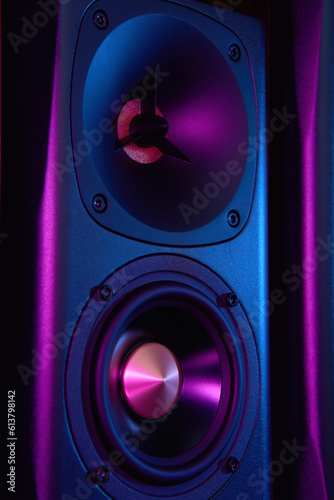 Multimedia acoustic sound speaker with neon lighting. Sound audio system on dark background.