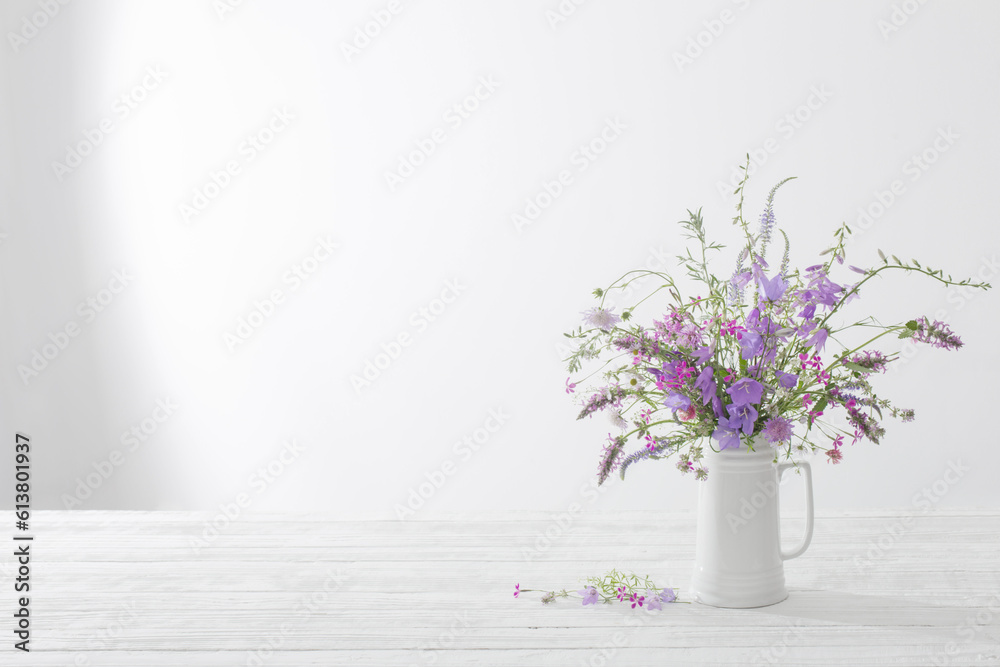 summer wild flowers in white jug on white background summer wild flowers in white jug on white background