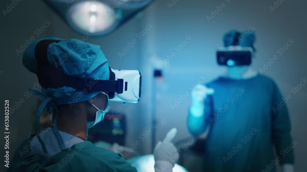 Two professional medical man and woman wearing VR virtual reality goggles touching on the air talking and discuss for treatment. Metaverse technology concept, Futuristic lifestyle