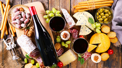 composition with red wine,  cheese selection and snacks