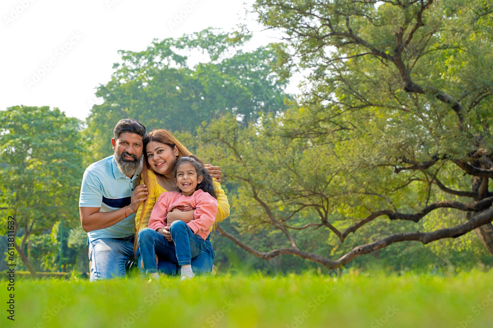 Happy indian couple with his little girl at garden. Happy indian couple with his little girl at garden.