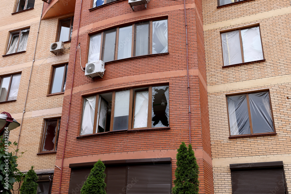 Fototapeta premium War between Ukraine and Russia. Shell fragments damaged the Business center and residential buildings. Damaged facade, broken windows of the house.