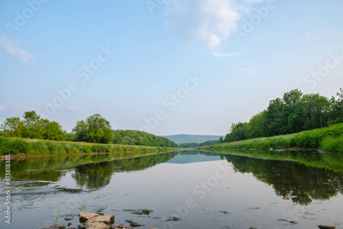Copy space image of river with water surface reflection mountain valley park land 