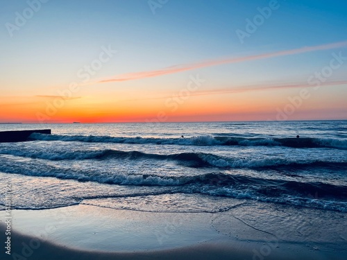 Orange sea coast  twilights at the sea  sandy coastline  natural evening seascape background