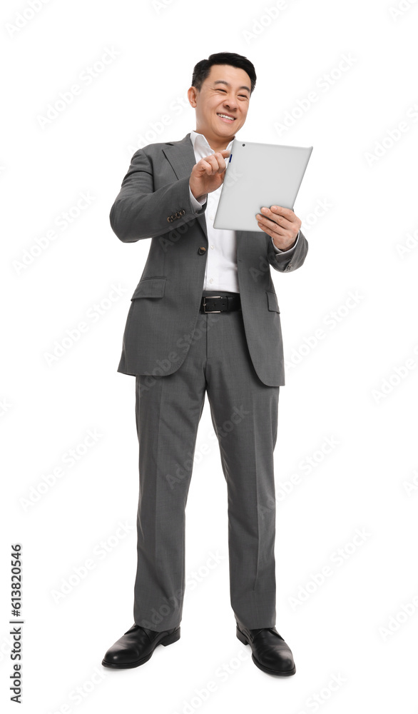 Businessman in suit using tablet on white background, low angle view Businessman in suit using tablet on white background, low angle view