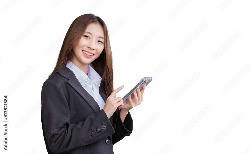 Young professional Asian businesswoman in a white shirt and dark blue suit is standing confidently smiling and looking at the camera while using smartphone isolated on white color background. Young professional Asian businesswoman in a white shirt and dark blue suit is standing confidently smiling and looking at the camera while using smartphone isolated on white color background.