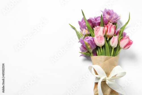 Beautiful bouquet of colorful tulip flowers on white background, top view. Space for text