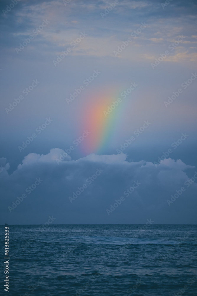 Rainbow Over the Sea Calm Water in the Evening after Raine