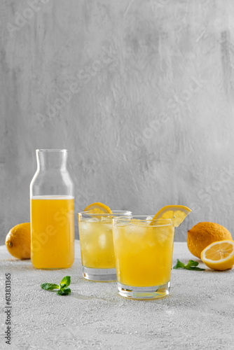 Fresh summer cocktail with lemons, mint and ice. Freshly made lemonade. Summer drinks and vacation concept. Cold refreshing drink