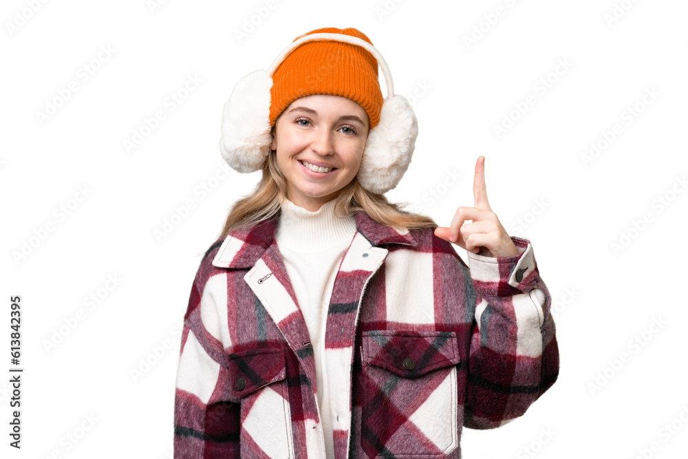 Young English woman wearing winter muffs over isolated background showing and lifting a finger in sign of the best Young English woman wearing winter muffs over isolated background showing and lifting a finger in sign of the best