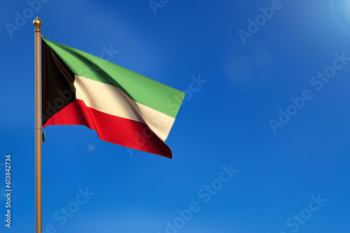 Kuwait. Flag blown by the wind with blue sky in the background