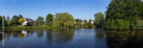 Lake and houses at village. Uffelte Drenthe Netherlands. Panorama.