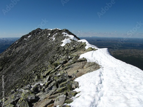 View to the top of Gaustatoppen, the highest mountain in Telemark, Norway. Most people stop the hike at the DNT cabin and the radio tower, but to get to the summit point one has to cross a saddle.