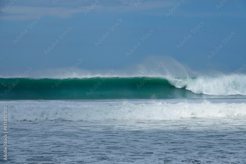 Amazing blue closeout wave during cleanup set breaking along Pacific coastline