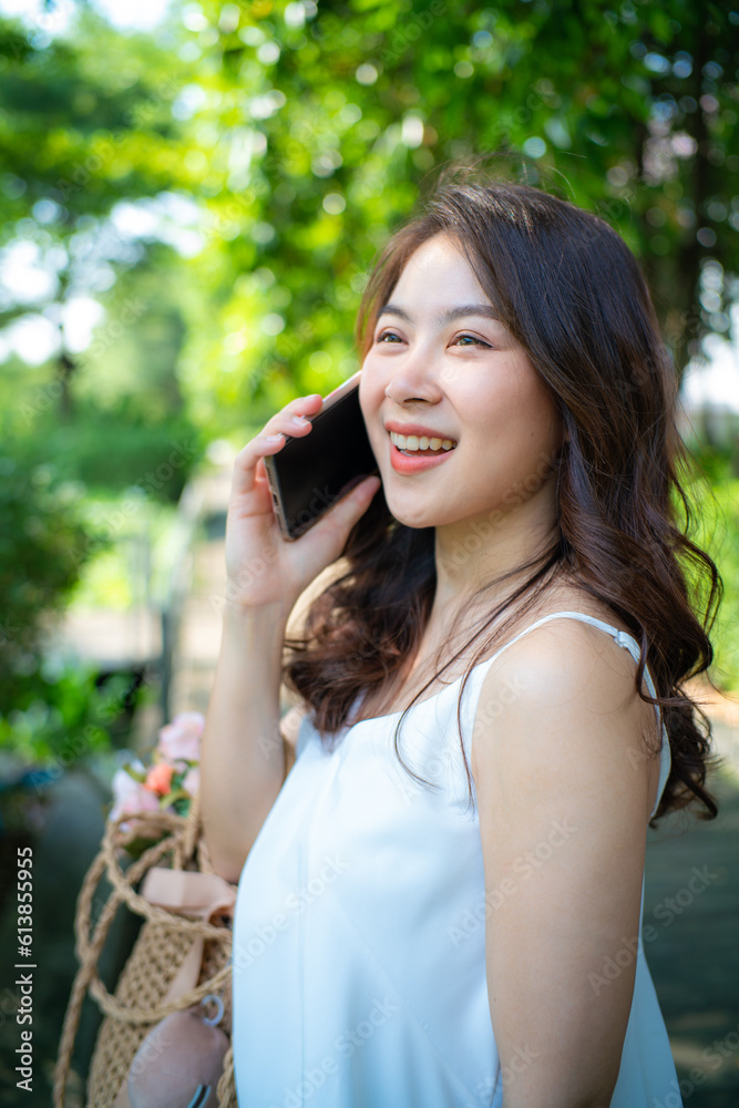 Beautiful asian woman use smartphone recreation in city public park Beautiful asian woman use smartphone recreation in city public park
