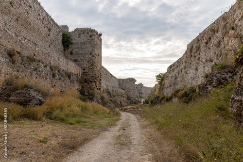 Stone wall fortifications in moat of old town of Rhodes, Greece
