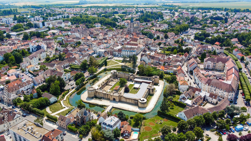 Aerial view of the square-based medieval castle of Brie Comte Robert surrounded with a water-filled moat in the French department of Seine et Marne in the capital region of Ile-de-France near Paris photo