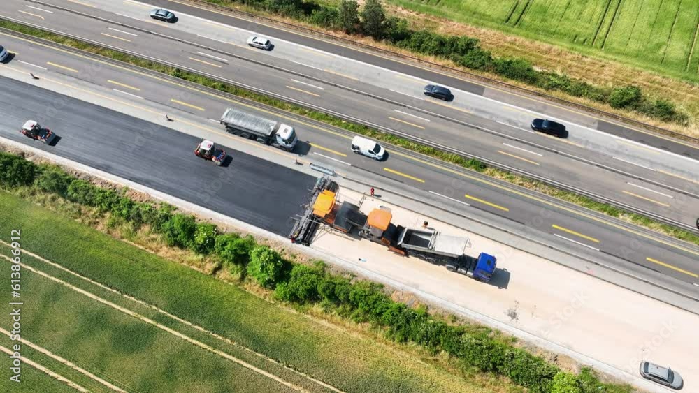 Large construction site - road works, asphalt paving machine. Aerial view