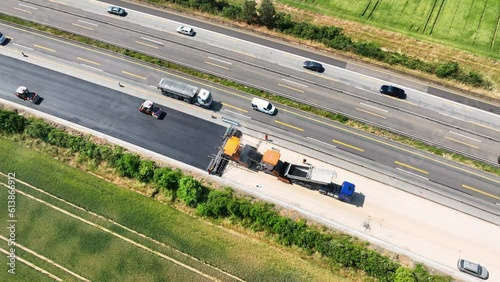 Large construction site - road works, asphalt paving machine. Aerial view