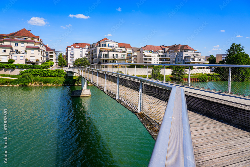 Footbridge spanning the Marne river to reach a residential neighborhood with many new apartment buildings in Meaux, Seine et Marne, France