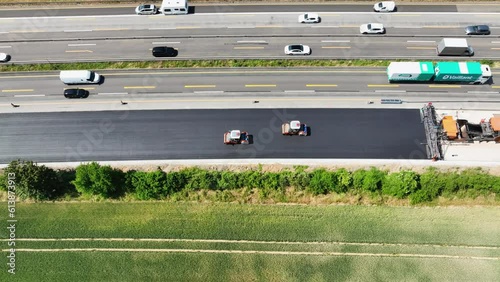 Large construction site - road works, asphalt paving machine. Aerial view