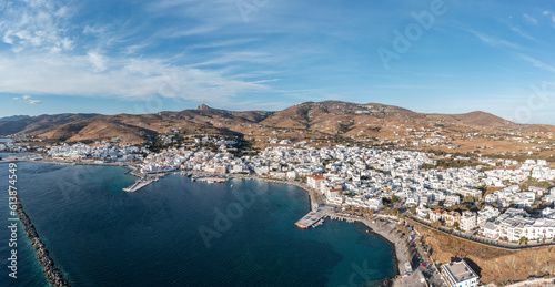 Tinos island Hora town Cyclades destination Greece. Aerial drone view of harbor breakwater sea sky.