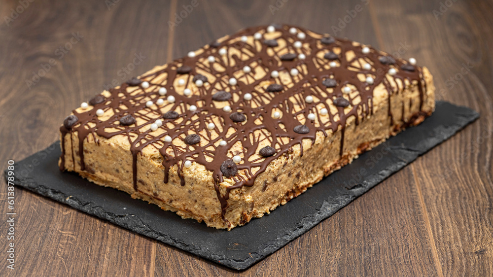 Homemade chocolate cake with nut cream on a wooden table