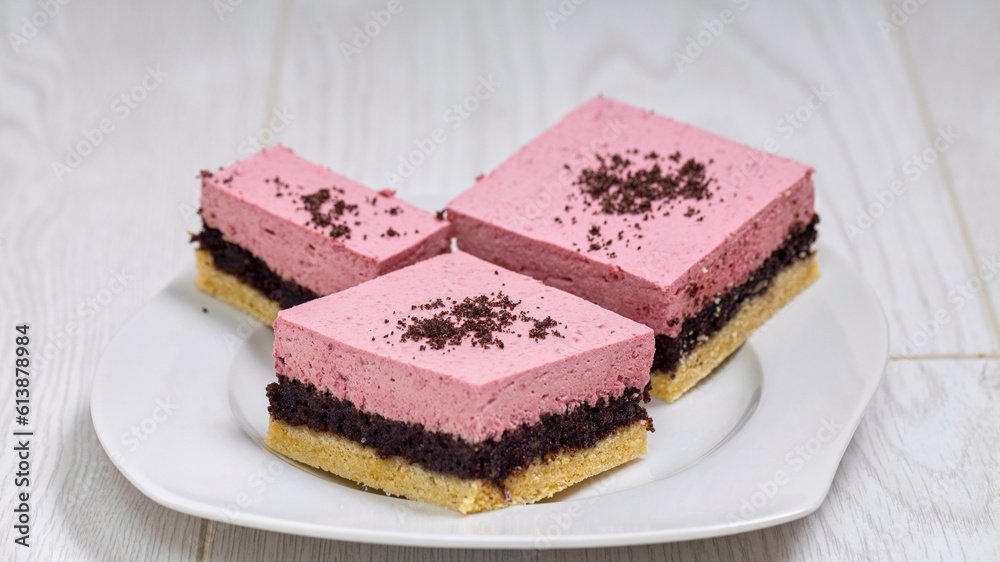 Layered cake with strawberries cream and poppy seed decorated with some poppy seed on top