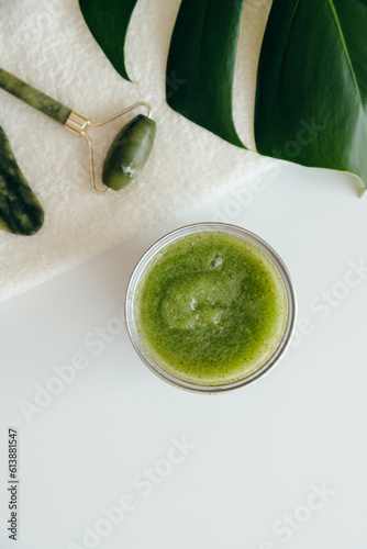 Green Natural Scrub with Sea Salt, Olive oil and Green Tea in Sealed Jar on white