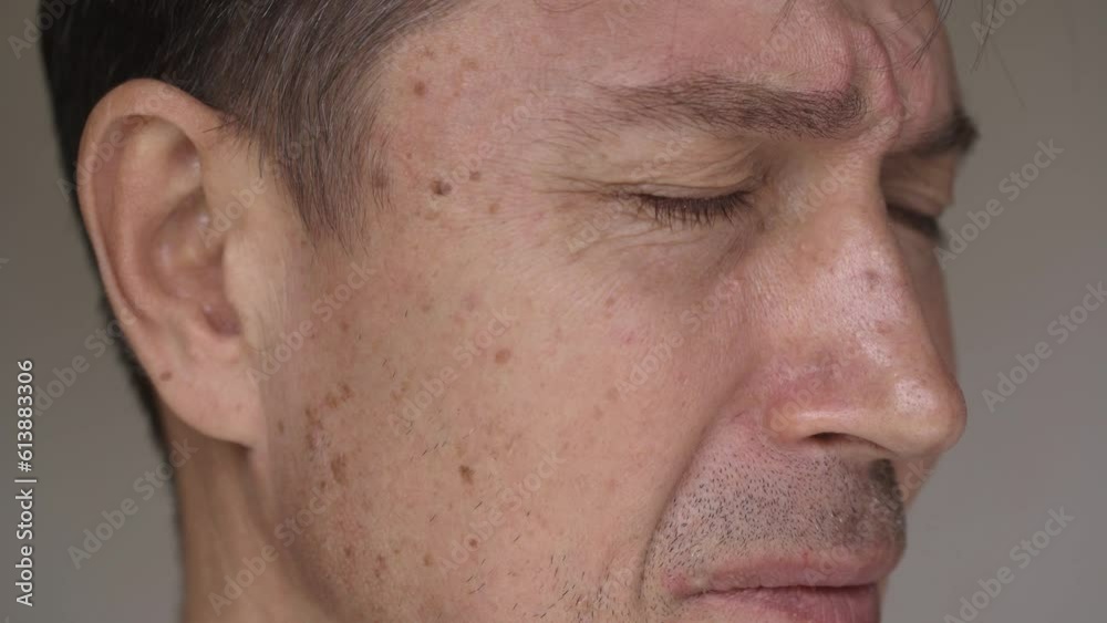 Close-up face middle-aged crying man with tightly closing eyes. The concept of a man's life crisis, health problems and sad news 4K Close-up face middle-aged crying man with tightly closing eyes. The concept of a man's life crisis, health problems and sad news 4K
