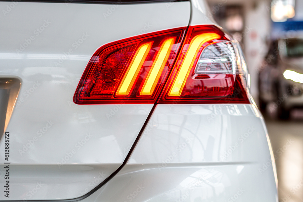 the rear lights of a modern white car, auto taillights