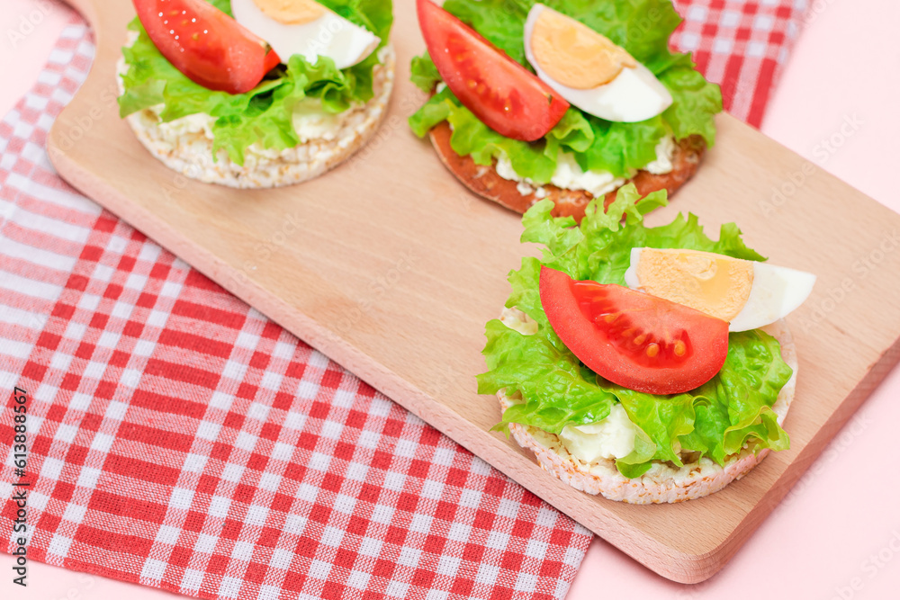 Rice Cake Sandwiches with Tomato, Lettuce and Egg on Wooden Cutting Board. Easy Breakfast. Diet Food. Quick and Healthy Sandwiches. Crispbread with Tasty Filling. Healthy Dietary Snack Rice Cake Sandwiches with Tomato, Lettuce and Egg on Wooden Cutting Board. Easy Breakfast. Diet Food. Quick and Healthy Sandwiches. Crispbread with Tasty Filling. Healthy Dietary Snack