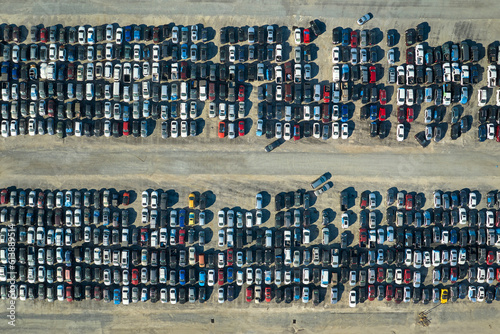 Aerial view of auction reseller company big parking lot with parked cars ready for remarketing services. Sales of secondhand vehicles