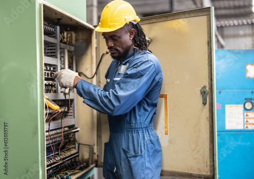 Electrical technician tests wiring, polarity, grounding, voltages and performs electrical maintenance using hand tools that involve clamp meter, screwdriver, and cutter. The foreman's routine tasks.
