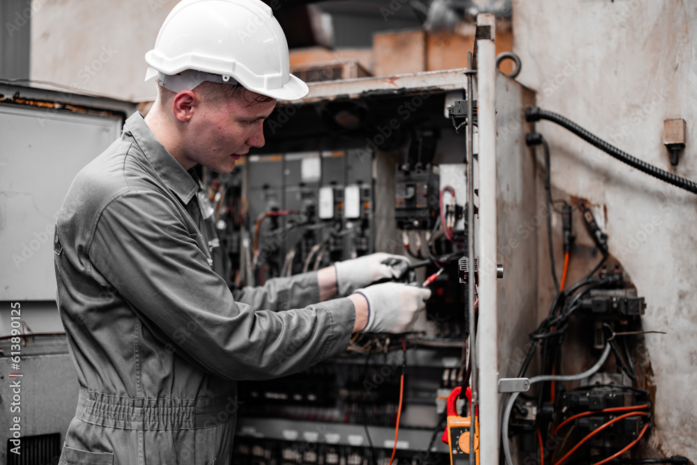 Fototapeta Electrical technician tests wiring, polarity, grounding