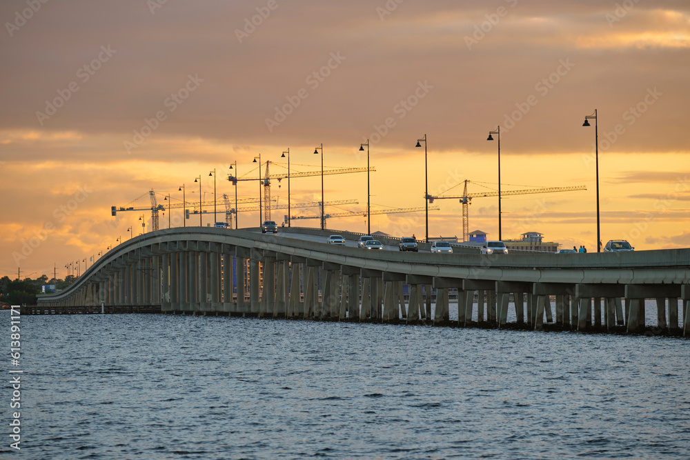 Fototapeta premium Barron Collier Bridge and Gilchrist Bridge in Florida with moving traffic. Transportation infrastructure in Charlotte County connecting Punta Gorda and Port Charlotte over Peace River