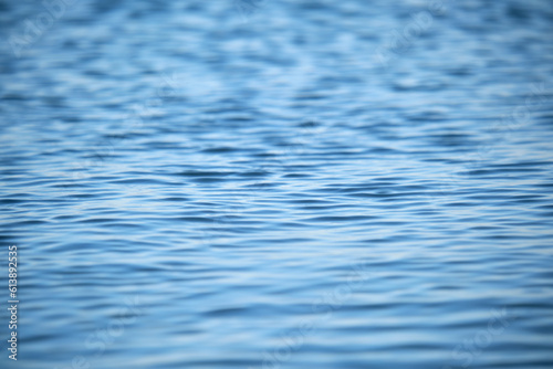 Closeup seascape surface of blue sea water with small ripple waves