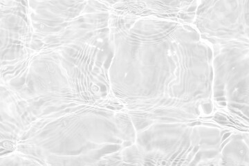 White water with ripples on the surface. Defocus blurred transparent white colored clear calm water surface texture with splashes and bubbles. Water waves with shining pattern texture background.