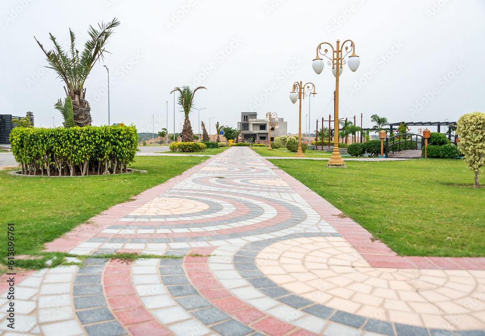 Fototapeta premium A public park in Kharian City, Pakistan, with a wooden bridge and pathway.