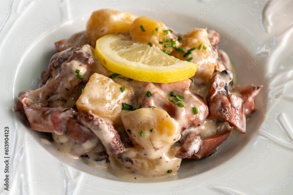Tastes od Camargue, Provence, hot dish salad with boiled octopus, potatoes and white sauce, served in French restaurant