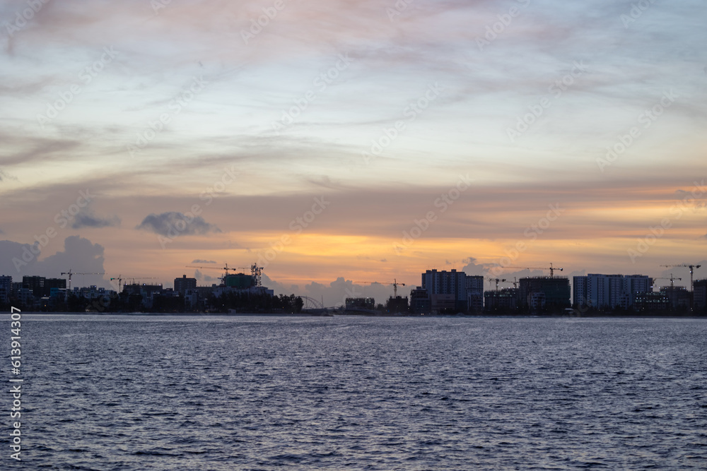 Huge buildings with sunset or sunrise, with sky and sea in a tropical island | Hiyaa flat of Maldives