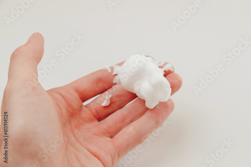 Man Hand with White oil Shaving Foam